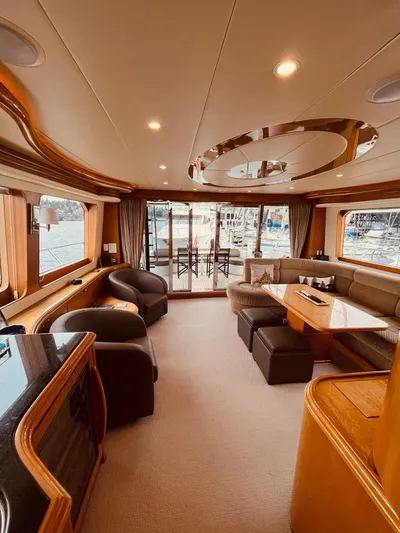 "conumdrum" Yacht Photos Pics Luxurious interior of 2007 Regency Yachts 670 Pilothouse with elegant seating and large windows.