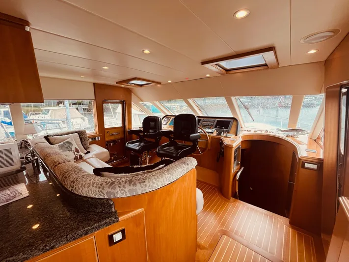 "conumdrum" Yacht Photos Pics Luxurious 2007 Regency Yachts 670 Pilothouse interior with elegant seating and modern helm.