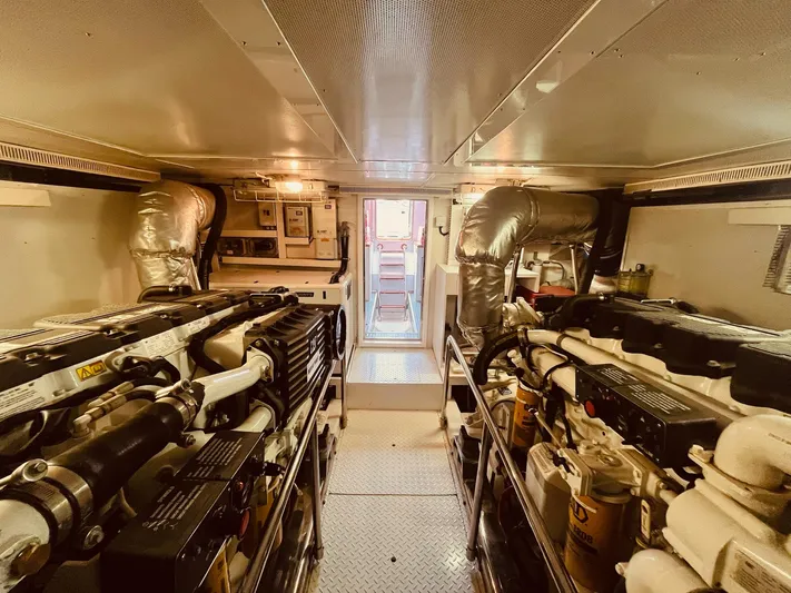"conumdrum" Yacht Photos Pics Engine room of 2007 Regency Yachts 670 Pilothouse, featuring dual engines and control systems.