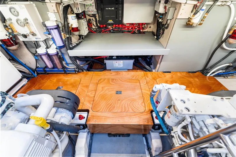 Kokomo Yacht Photos Pics Engine room of a 2016 Sea Ray 510 Fly yacht, showcasing equipment and wooden flooring.