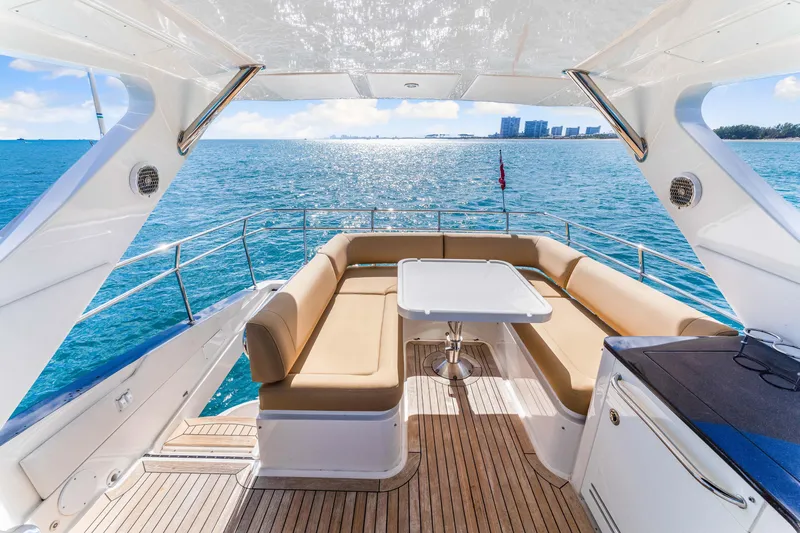 Kokomo Yacht Photos Pics Luxurious 2016 Sea Ray 510 Fly yacht deck with seating, ocean view, and city skyline.