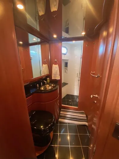 "conumdrum" Yacht Photos Pics Luxurious bathroom in a 2007 Regency Yachts 670 Pilothouse with elegant wood finishes.
