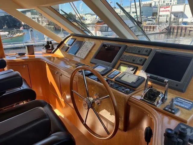 "conumdrum" Yacht Photos Pics 2007 Regency Yachts 670 Pilothouse helm with navigation equipment and waterfront view.