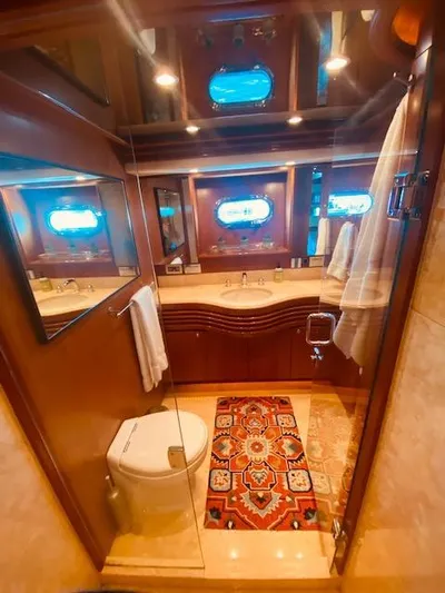 "conumdrum" Yacht Photos Pics Luxurious bathroom in a 2007 Regency Yachts 670 Pilothouse with elegant wood finishes.