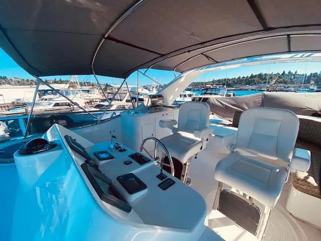 "conumdrum" Yacht Photos Pics 2007 Regency Yachts 670 Pilothouse helm station with dual captain chairs.