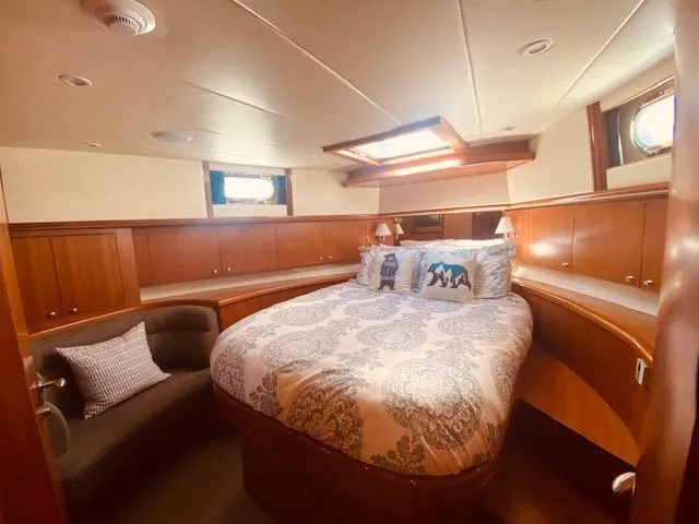 "conumdrum" Yacht Photos Pics Luxurious bedroom in 2007 Regency Yachts 670 Pilothouse with elegant wood paneling.