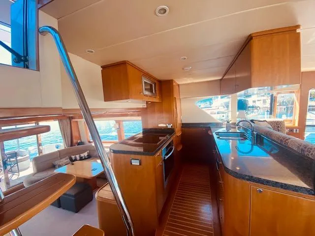 "conumdrum" Yacht Photos Pics Interior of 2007 Regency Yachts 670 Pilothouse, featuring modern kitchen and spacious living area.