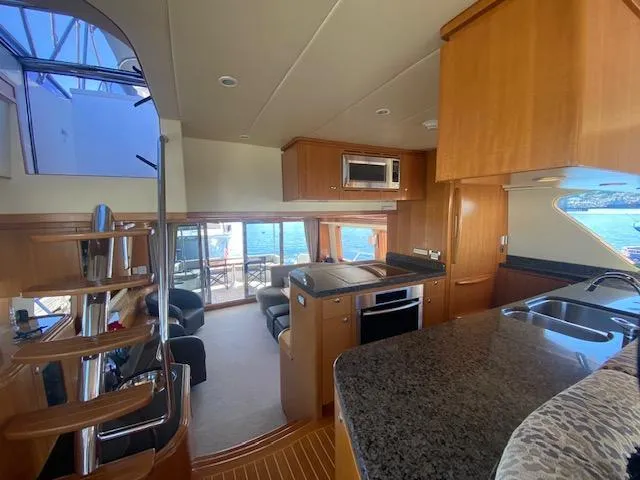 "conumdrum" Yacht Photos Pics Luxurious interior of 2007 Regency Yachts 670 Pilothouse with modern kitchen and seating area.