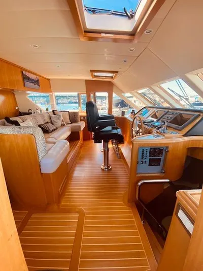 "conumdrum" Yacht Photos Pics Luxurious interior of 2007 Regency Yachts 670 Pilothouse with plush seating and modern helm.