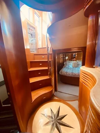 "conumdrum" Yacht Photos Pics Luxurious interior of 2007 Regency Yachts 670 Pilothouse with wooden staircase and cozy bedroom.