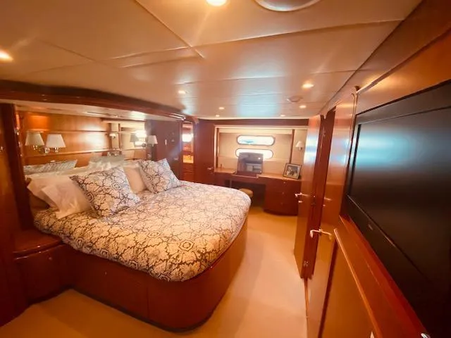 "conumdrum" Yacht Photos Pics Luxurious bedroom in 2007 Regency Yachts 670 Pilothouse with elegant wood finishes.