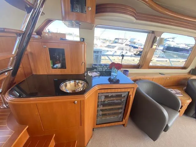 "conumdrum" Yacht Photos Pics Luxurious interior of 2007 Regency Yachts 670 Pilothouse with bar and seating area.