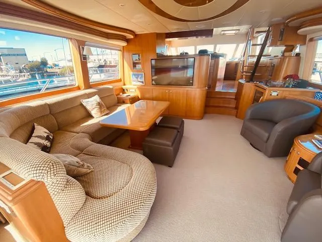 "conumdrum" Yacht Photos Pics Luxurious interior of 2007 Regency Yachts 670 Pilothouse with plush seating and large windows.