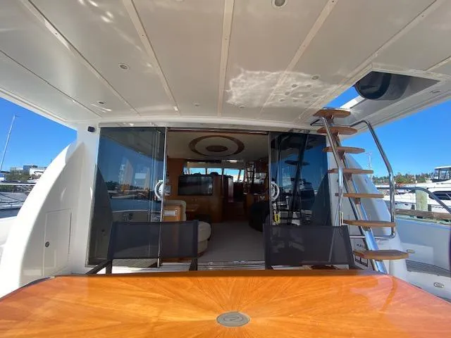 "conumdrum" Yacht Photos Pics 2007 Regency Yachts 670 Pilothouse aft deck with table and stairs.