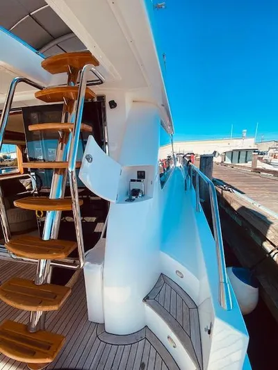 "conumdrum" Yacht Photos Pics 2007 Regency Yachts 670 Pilothouse, exterior view with wooden steps and dock.