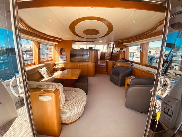 "conumdrum" Yacht Photos Pics Luxurious interior of 2007 Regency Yachts 670 Pilothouse with elegant seating and large windows.