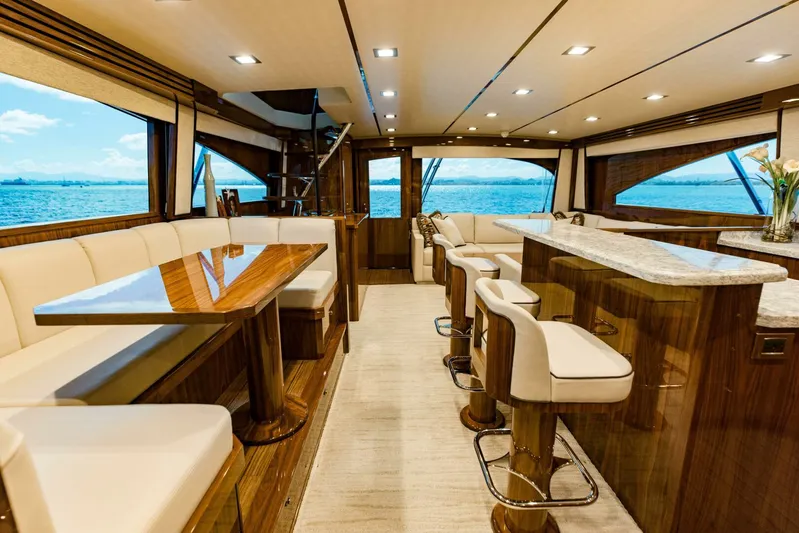 Sari Victoria Yacht Photos Pics Luxurious interior of 2020 Viking 72 yacht with elegant seating and ocean view.