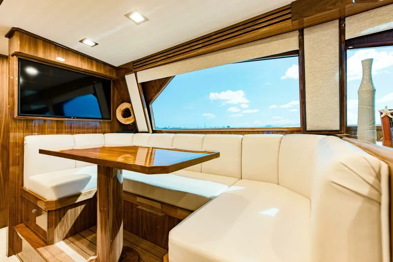 Sari Victoria Yacht Photos Pics Luxurious interior of 2020 Viking 72 yacht with elegant seating and large windows.