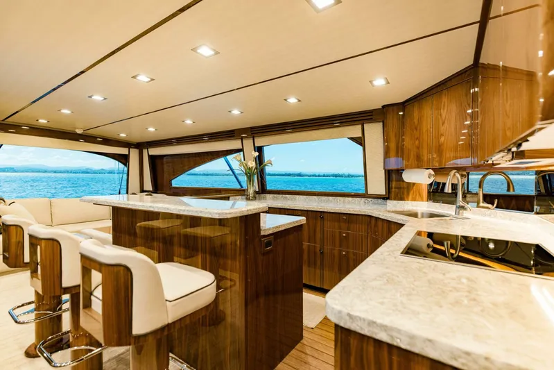 Sari Victoria Yacht Photos Pics Luxurious interior of 2020 Viking 72 yacht with elegant wood finishes and ocean view.