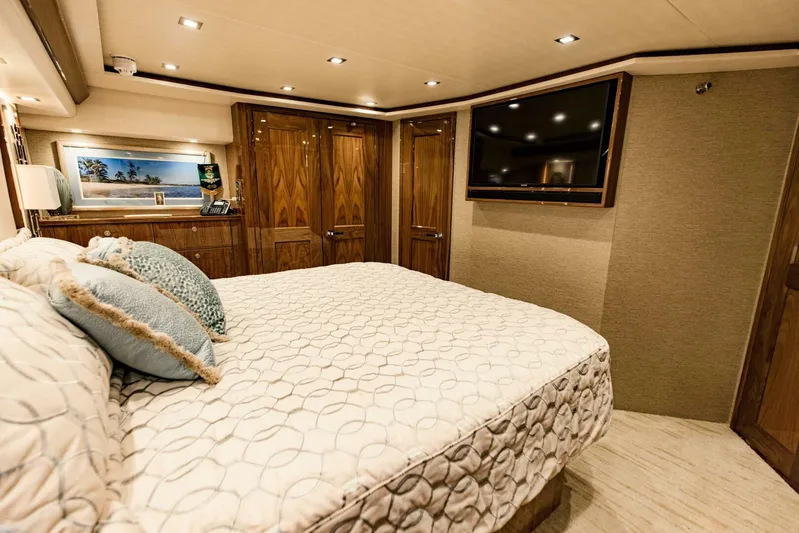 Sari Victoria Yacht Photos Pics Luxurious bedroom interior of 2020 Viking 72 yacht with elegant wood finishes and modern amenities.
