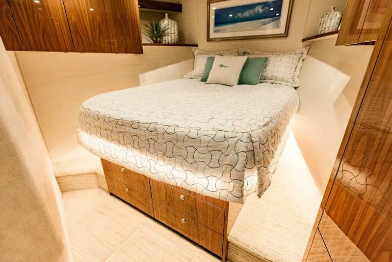 Sari Victoria Yacht Photos Pics Luxurious bedroom interior of 2020 Viking 72 yacht with elegant bedding and wooden cabinetry.