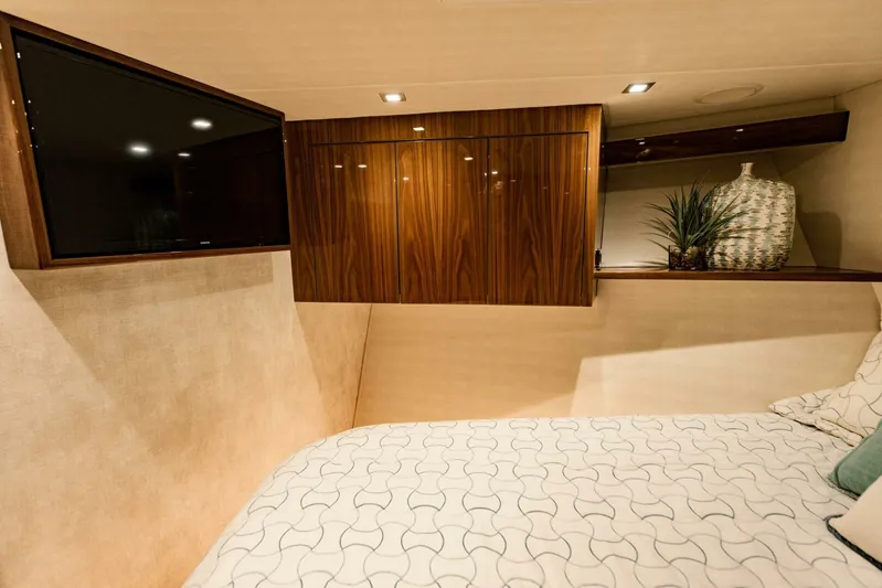 Sari Victoria Yacht Photos Pics Luxurious cabin interior of 2020 Viking 72 yacht with TV and elegant decor.