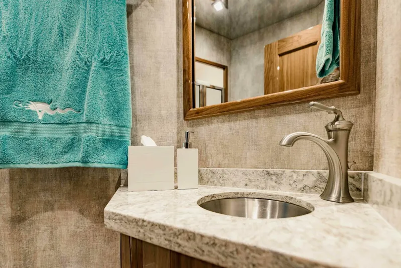 Sari Victoria Yacht Photos Pics Modern bathroom in 2020 Viking 72 yacht with marble countertop and teal towel.