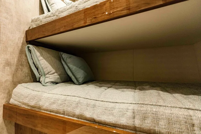 Sari Victoria Yacht Photos Pics Bunk beds in 2020 Viking 72 yacht, featuring cozy bedding and wooden accents.