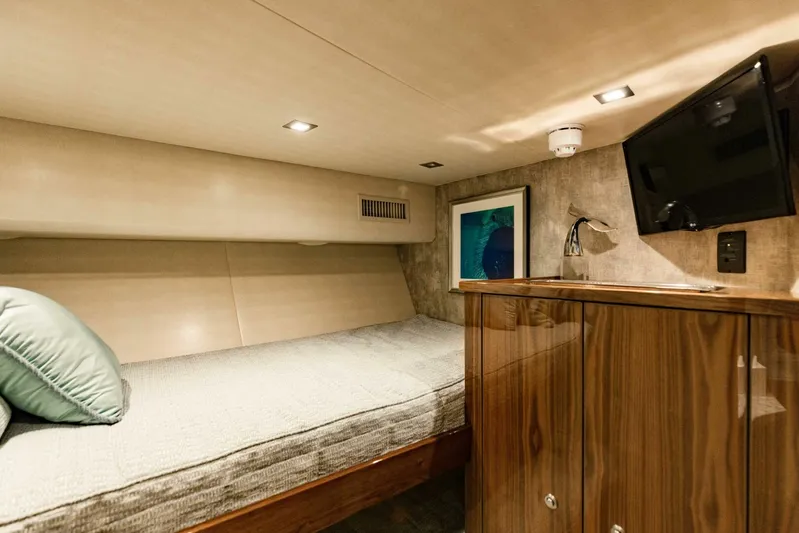 Sari Victoria Yacht Photos Pics Luxurious cabin interior of 2020 Viking 72 yacht with bed, TV, and wooden cabinetry.