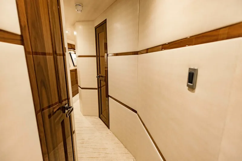 Sari Victoria Yacht Photos Pics Luxurious hallway interior of 2020 Viking 72 yacht with wooden accents.