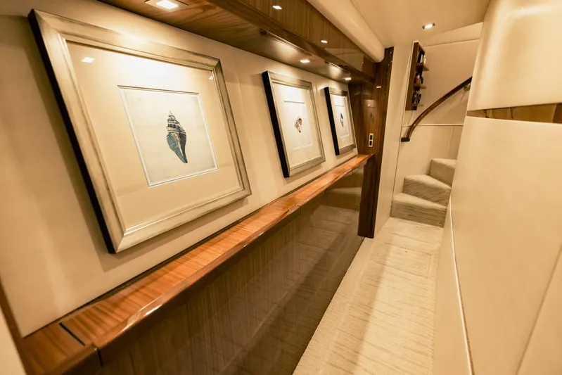 Sari Victoria Yacht Photos Pics Luxurious interior hallway of 2020 Viking 72 yacht with framed artwork and elegant lighting.