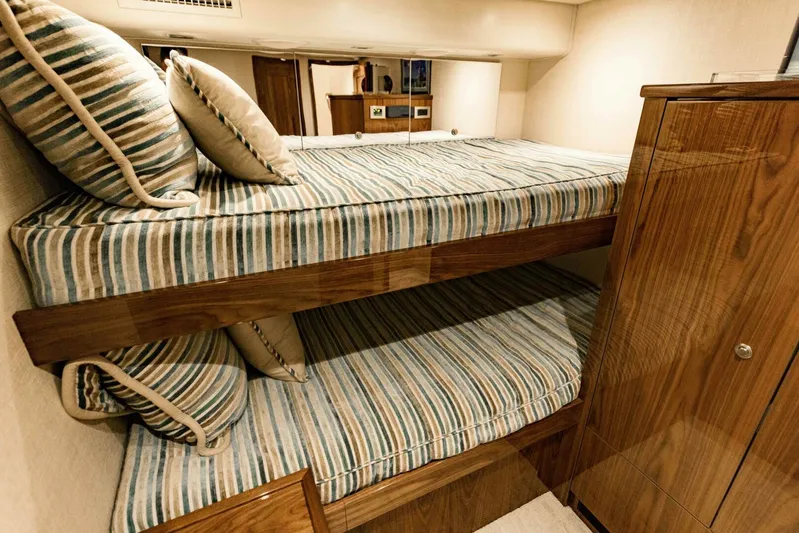 Sari Victoria Yacht Photos Pics Bunk beds with striped bedding in a 2020 Viking 72 yacht cabin.