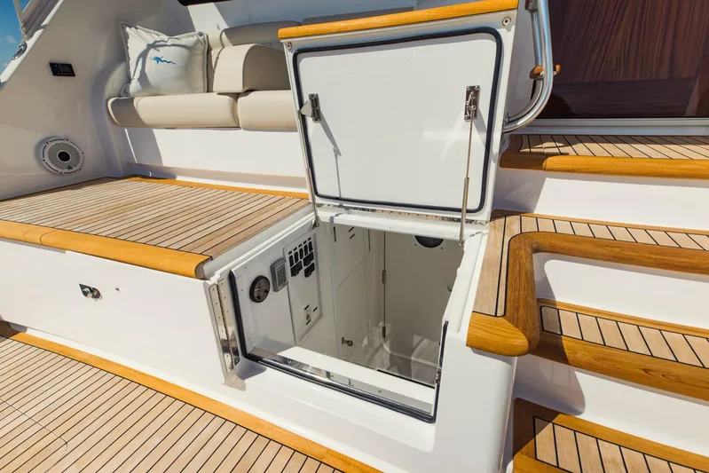 Sari Victoria Yacht Photos Pics 2020 Viking 72 yacht with open hatch, teak deck, and cushioned seating.