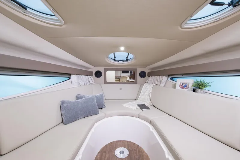 Don't Ask Yacht Photos Pics Manufacturer Provided Image: Interior of 2018 Regal 28 Express boat with beige seating and skylights.