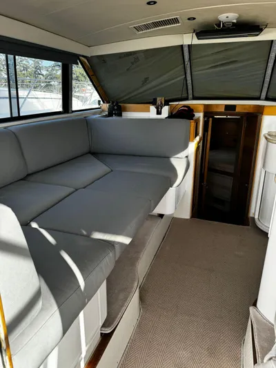 Three Wishes Yacht Photos Pics Interior of 2000 Bertram 36 SF yacht with gray seating and carpeted floor.