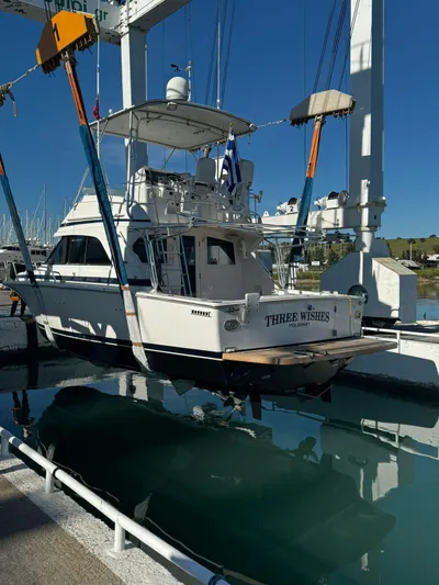 Three Wishes Yacht Photos Pics Bertram 36 SF 2000 yacht "Three Wishes" in dry dock, marina background.