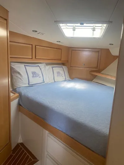 Three Wishes Yacht Photos Pics Cozy cabin interior of 2000 Bertram 36 SF yacht with skylight and bed.