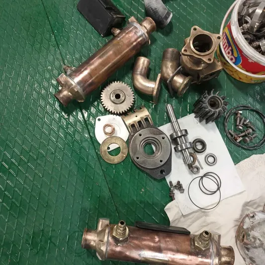 Three Wishes Yacht Photos Pics Assorted mechanical parts on green surface, including gears and pipes, for Bertram 36 sf 2000.