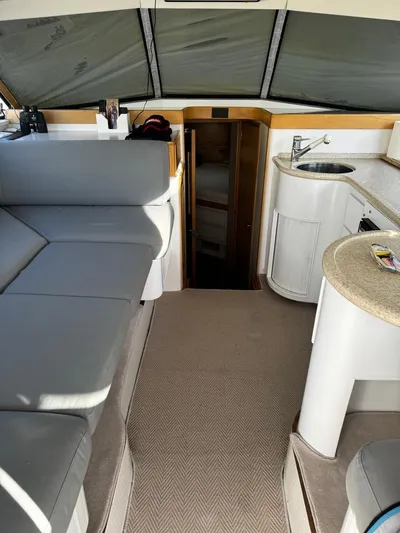 Three Wishes Yacht Photos Pics Interior of a 2000 Bertram 36 SF yacht with seating and kitchenette.