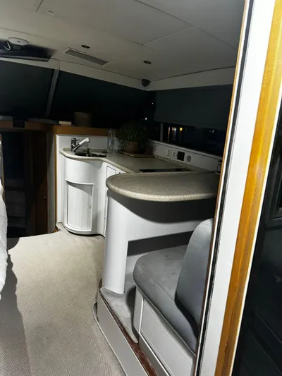 Three Wishes Yacht Photos Pics Interior of a 2000 Bertram 36 SF yacht, featuring a compact kitchen area.