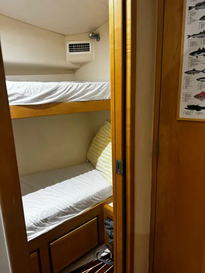 Three Wishes Yacht Photos Pics Cozy bunk beds in a 2000 Bertram 36 SF cabin with wooden accents.