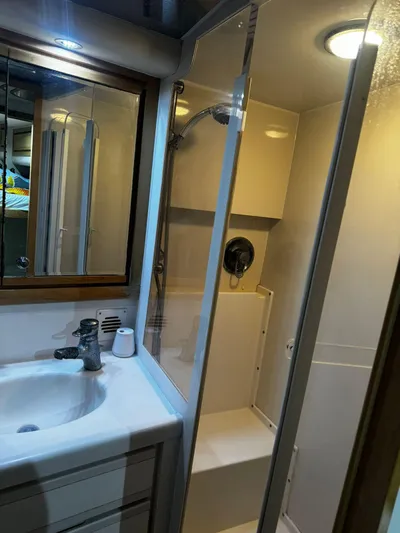 Three Wishes Yacht Photos Pics 2000 Bertram 36 SF yacht bathroom with shower, sink, and mirror.