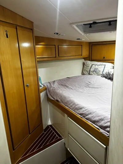 Three Wishes Yacht Photos Pics Cozy cabin interior of 2000 Bertram 36 SF with wood cabinetry and bed.
