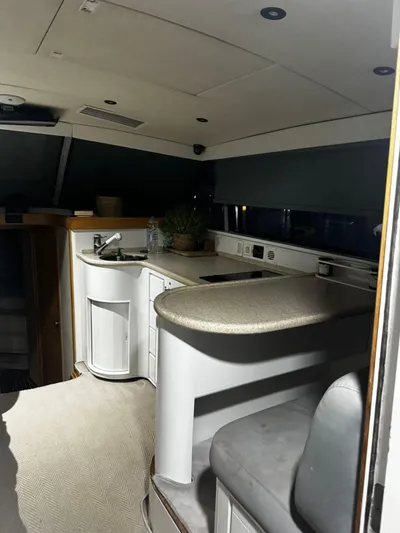 Three Wishes Yacht Photos Pics Interior of a 2000 Bertram 36 SF yacht, featuring a compact kitchen area.