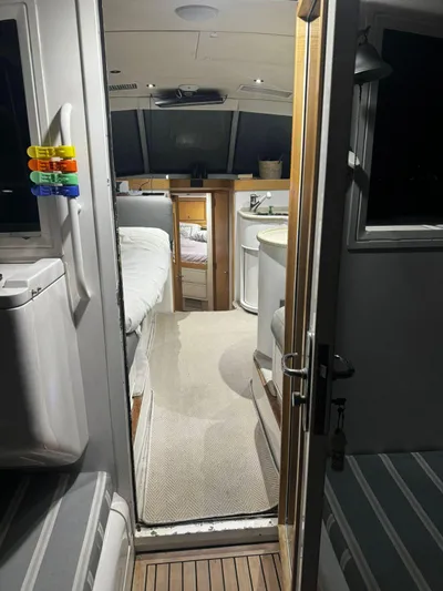 Three Wishes Yacht Photos Pics Interior view of a 2000 Bertram 36 SF boat, featuring cozy cabin and seating area.