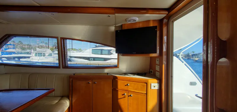 Mai Time Yacht Photos Pics Interior of 2001 Bertram 390 Convertible yacht with wood cabinetry and window view.