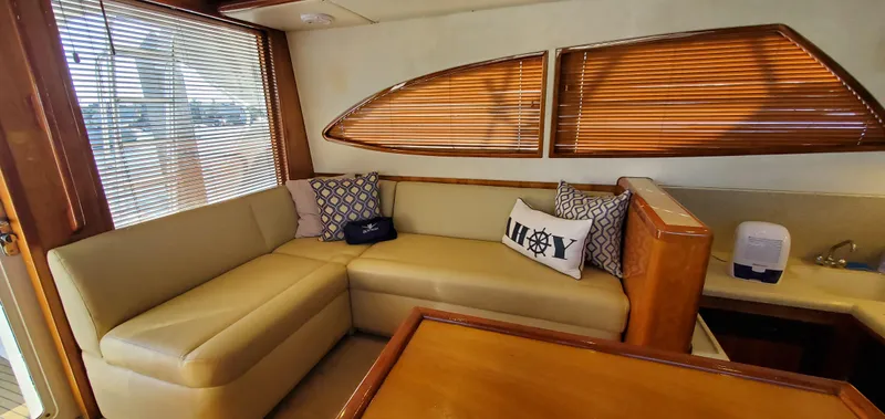 Mai Time Yacht Photos Pics Interior of 2001 Bertram 390 Convertible yacht with beige seating and wooden accents.