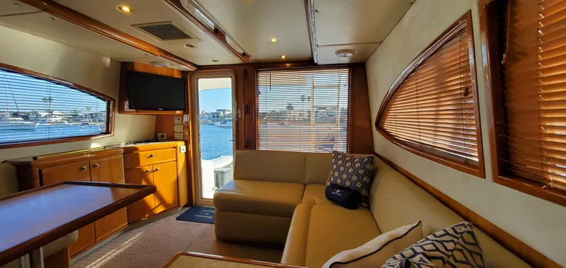Mai Time Yacht Photos Pics Interior of 2001 Bertram 390 Convertible yacht with cozy seating and wooden accents.