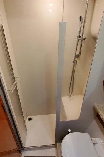 Mai Time Yacht Photos Pics Bathroom interior of 2001 Bertram 390 Convertible yacht with shower and toilet.