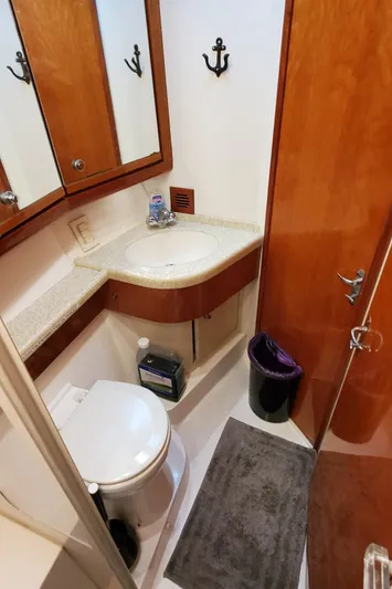 Mai Time Yacht Photos Pics 2001 Bertram 390 Convertible yacht bathroom with wood accents and compact design.